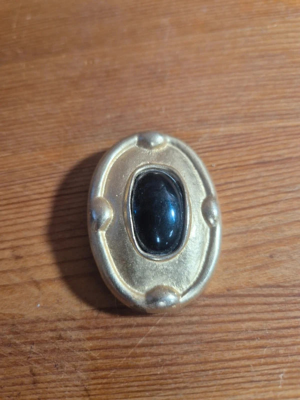 Gold tone and black brooch