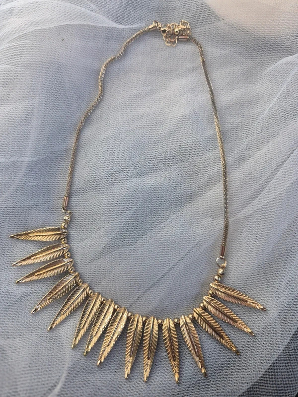 Gold tone feather necklace
