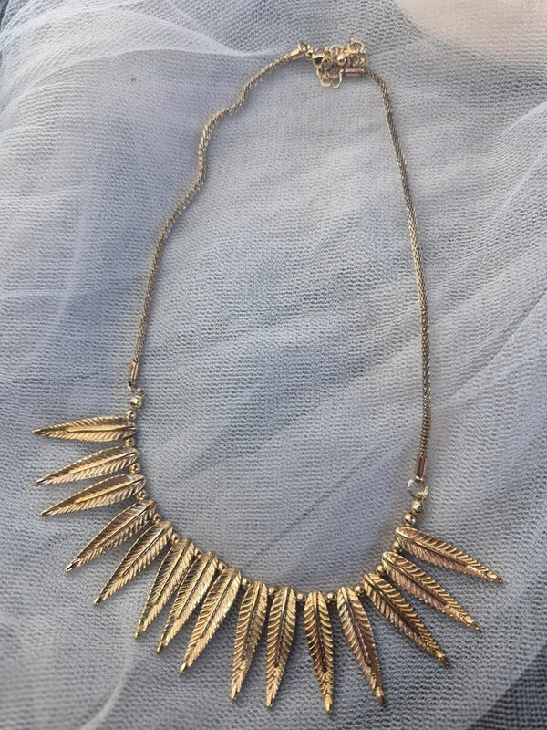 Gold tone feather necklace