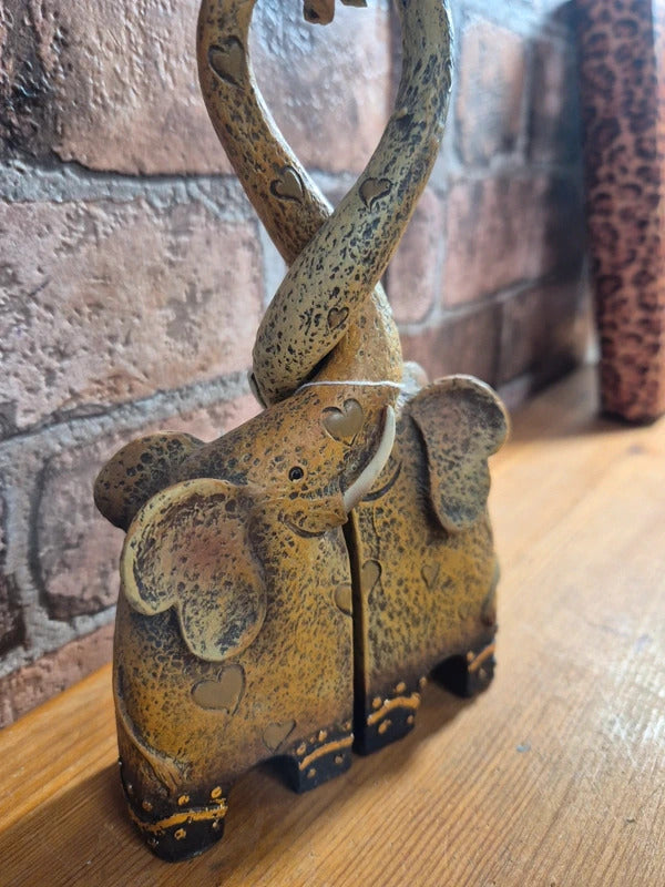 Intertwined elephant figure