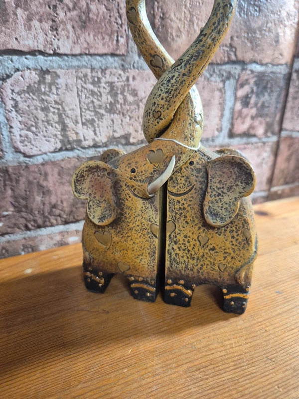 Intertwined elephant figure