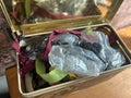 Bundle of zips and buttons in vintage tin