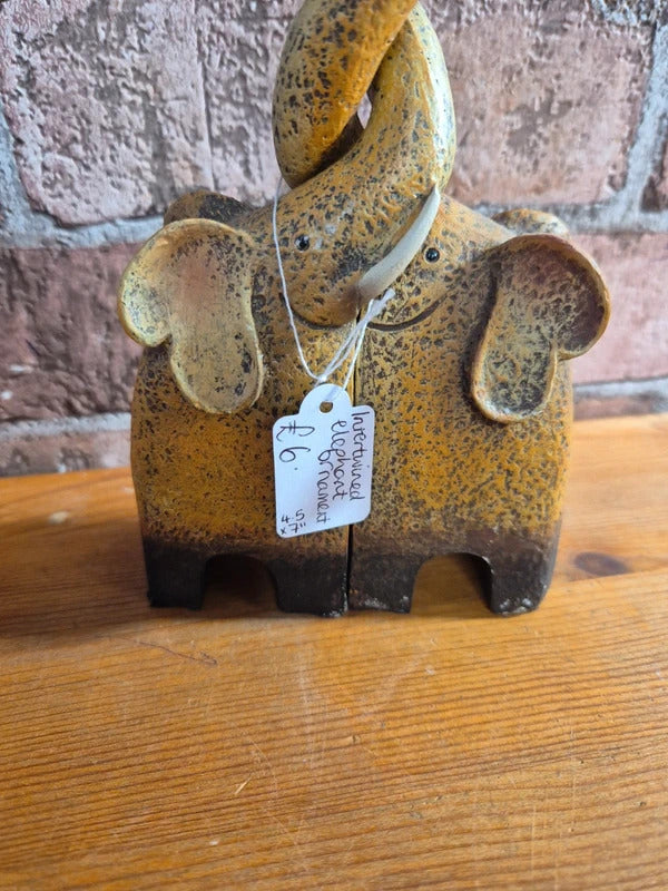 Intertwined elephant figure