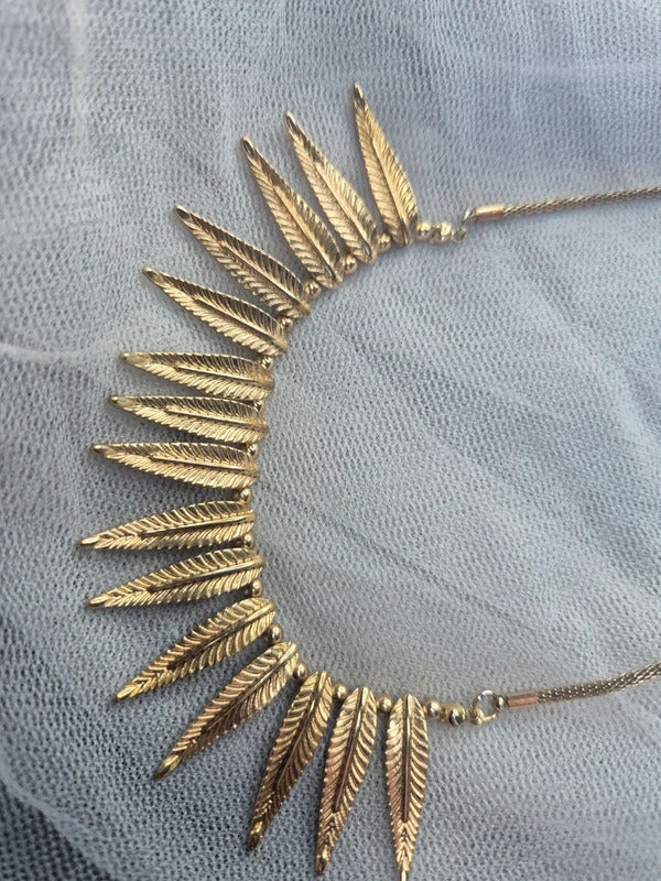 Gold tone feather necklace