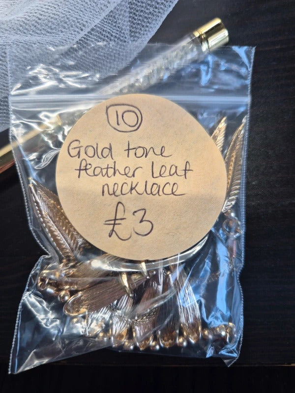 Gold tone feather necklace
