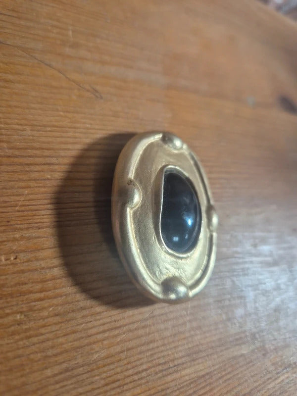 Gold tone and black brooch