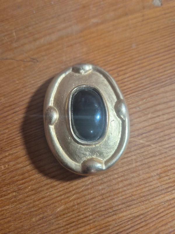 Gold tone and black brooch