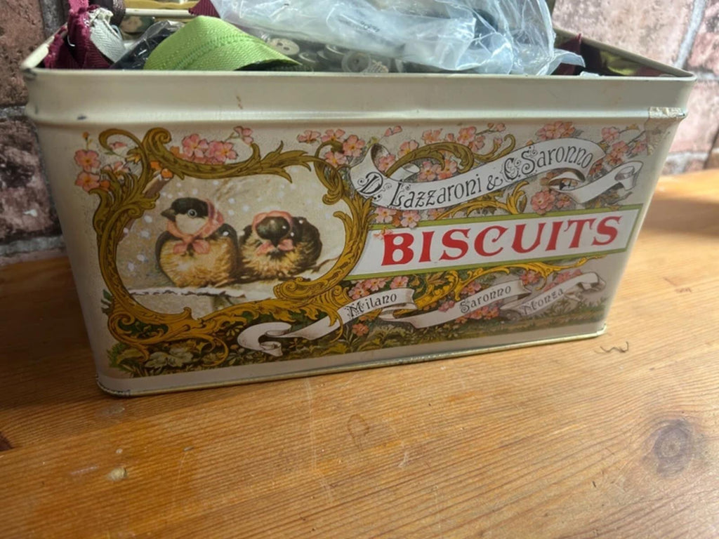 Bundle of zips and buttons in vintage tin