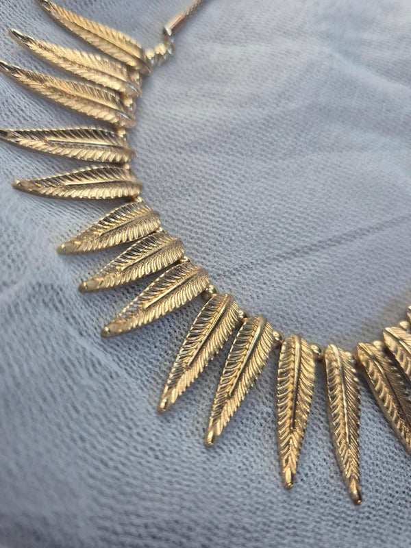 Gold tone feather necklace